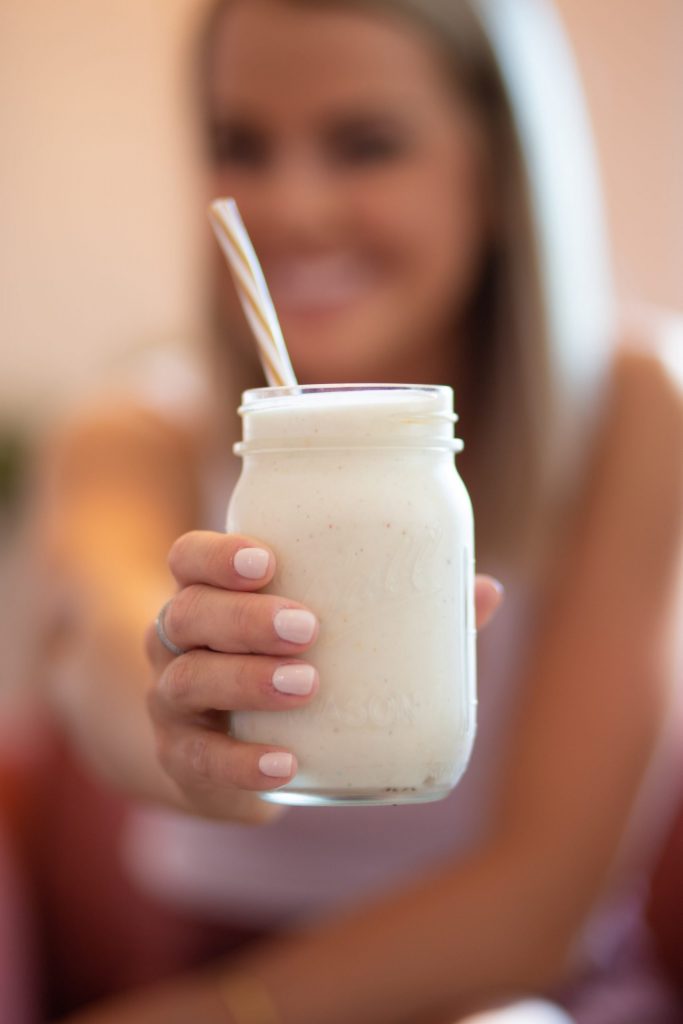woman holding smoothie